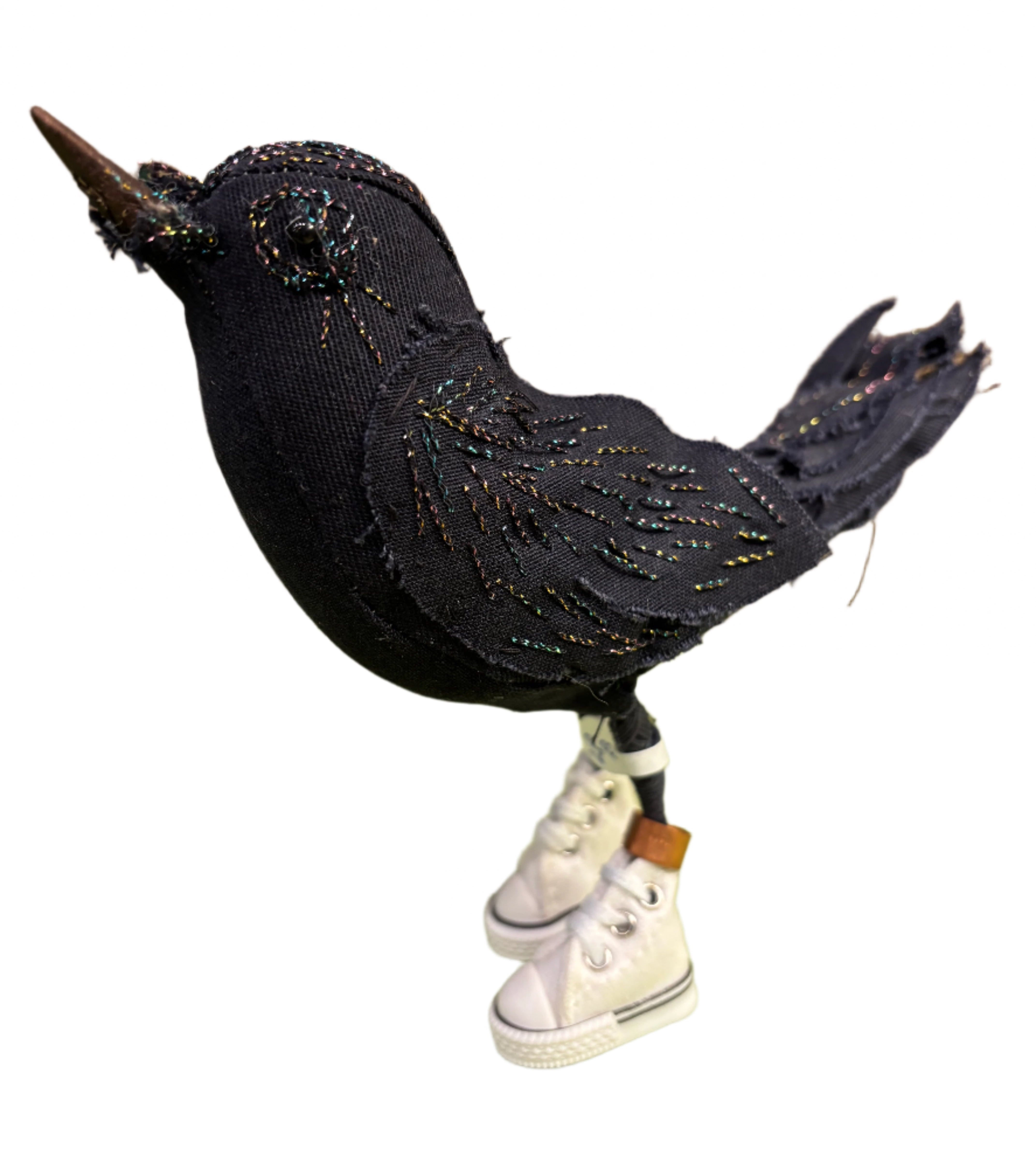 Black decorative fabric bird with metallic stitching details on a white background